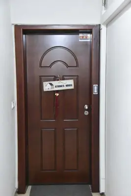 a wooden door with a sign on it at Your Ideal Retreat in the Heart of Kallithea in Athens