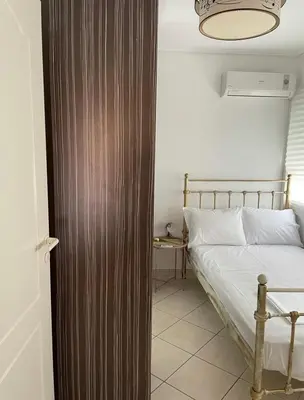 a bedroom with a bed and a wooden door at Konstantina's Cozy central place to enjoy Athens in Athens