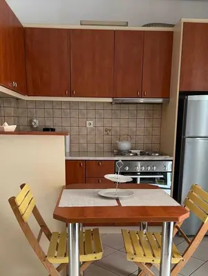 a kitchen with a wooden table and a stove at Konstantina's Cozy central place to enjoy Athens in Athens