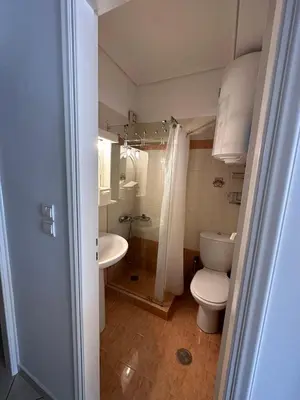 a bathroom with a toilet and a sink at Konstantina's Cozy central place to enjoy Athens in Athens