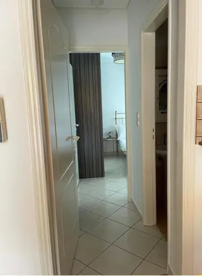 a hallway with a door leading to a bedroom at Konstantina's Cozy central place to enjoy Athens in Athens