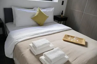 a bed with white towels and a tray on it at Athenean Porto Piraeus Suites -GF1 in Piraeus