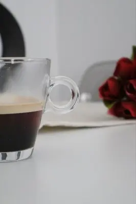 a cup of coffee next to a plate with roses at Athenean Porto Piraeus Suites -GF1 in Piraeus
