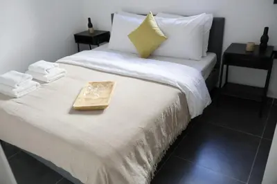 a bed with a tray on it with towels on it at Athenean Porto Piraeus Suites -GF1 in Piraeus