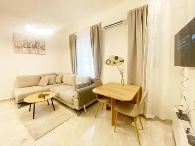a living room with a couch and a table at Piraiki in Piraeus