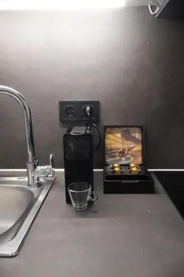 a kitchen counter top with a sink and a counter top with a sink at Athenean Porto Piraeus Suites -GF2 in Piraeus