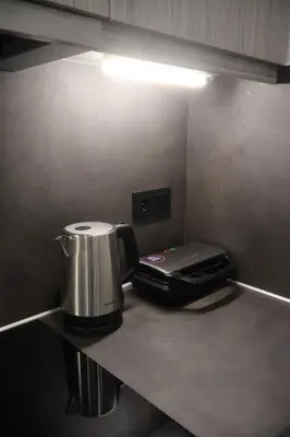 a coffee maker sitting on a counter in a kitchen at Athenean Porto Piraeus Suites -GF2 in Piraeus