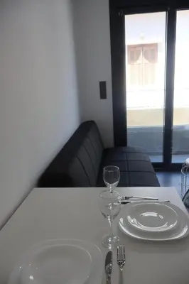 a table with two plates and a wine glass on it at Athenean Porto Piraeus Suites -A1 in Piraeus