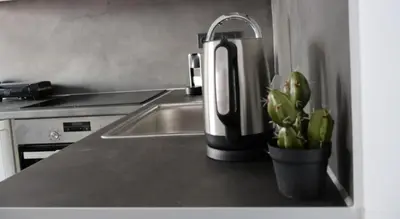 a kitchen counter with a sink and a coffee maker at Athenean Porto Piraeus Suites -A1 in Piraeus