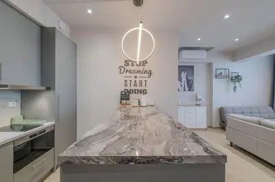 a kitchen with a marble counter top in a room at Minimal Style Apartment in Piraeus