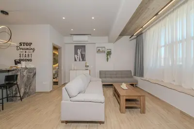 a living room with a couch and a table at Minimal Style Apartment in Piraeus