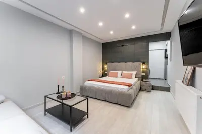 a bedroom with a bed and a couch and a table at Acropolis Nest in Athens