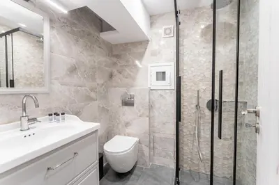 a bathroom with a shower and a toilet and a sink at Acropolis Nest in Athens