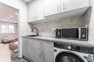 a kitchen with a microwave and a washer and dryer at Acropolis Nest in Athens