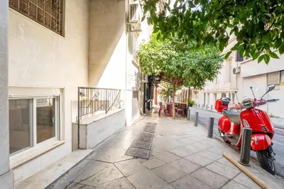 a red scooter parked on a sidewalk next to a building at Acropolis Nest in Athens
