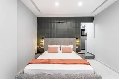 a bedroom with a large bed with two pink pillows at Acropolis Nest in Athens