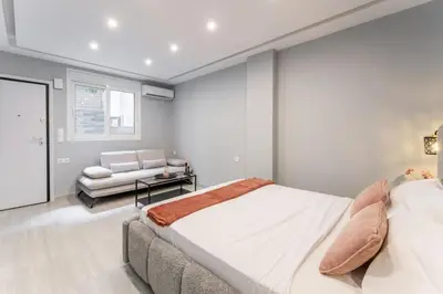 a bedroom with a bed and a couch at Acropolis Nest in Athens