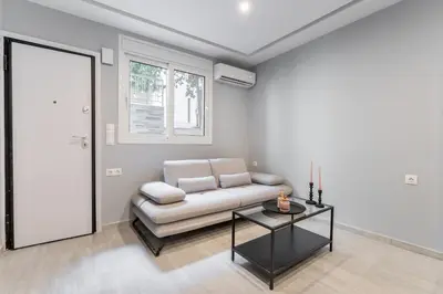 a living room with a couch and a table at Acropolis Nest in Athens