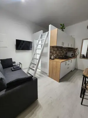 a living room with a couch and a kitchen at Kallithea VIP Apartments in Athens
