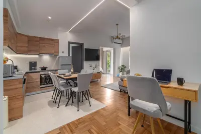a kitchen and living room with a table and chairs at Urban Nest 1 in Athens