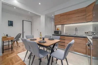 a kitchen and dining room with a table and chairs at Urban Nest 1 in Athens