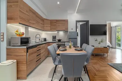 a kitchen and dining room with a table and chairs at Urban Nest 1 in Athens