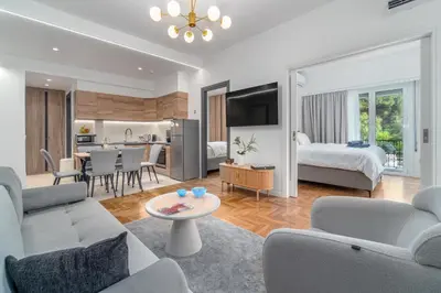 a living room with a couch and a bedroom at Urban Nest 1 in Athens