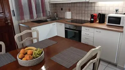 a kitchen with a table with a bowl of fruit on it at Adorable apartment in Athens