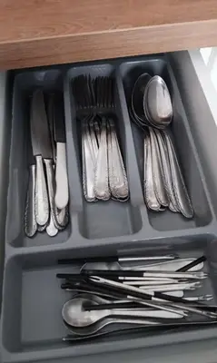 a tray of utensils sitting in a drawer at Adorable apartment in Athens