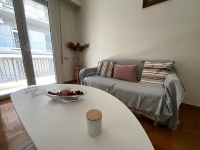 a living room with a table and a couch at The Kallimarmaro Nest in Athens