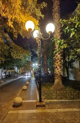 a street light on the side of a road at night at The Kallimarmaro Nest in Athens