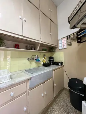 a kitchen with white cabinets and a sink at The Kallimarmaro Nest in Athens