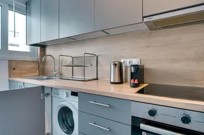 a kitchen with a sink and a washing machine at Relax in Style Petralona Modern Flat in Athens