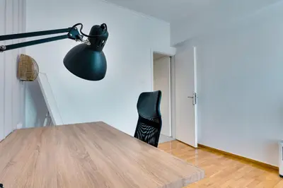 a desk with a black lamp and a black chair at Relax in Style Petralona Modern Flat in Athens