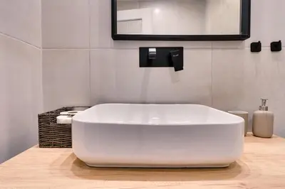 a white bath tub in a bathroom with a mirror at Relax in Style Petralona Modern Flat in Athens