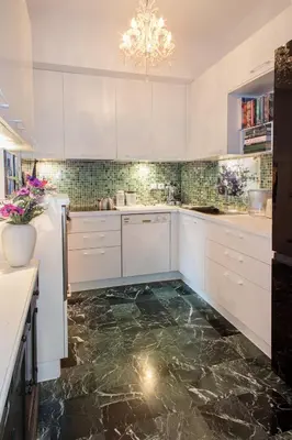a kitchen with marble floors and white cabinets and a chandelier at Elegant Private Home by the Acropolis in Athens