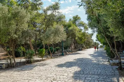 a cobblestone street with trees on either side at Elegant Private Home by the Acropolis in Athens