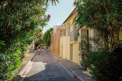 a couple of people walking down a street at Elegant Private Home by the Acropolis in Athens
