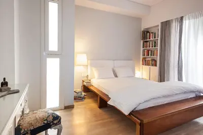 a bedroom with a bed and a book shelf at Elegant Private Home by the Acropolis in Athens