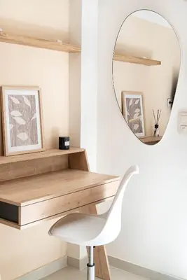 a white chair in front of a desk with a mirror at Central Modern Studio with balcony,1 min to Metro,10 min to Acropolis in Athens