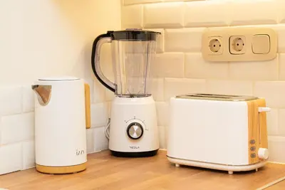 a blender and a toaster on a counter at Central Modern Studio with balcony,1 min to Metro,10 min to Acropolis in Athens