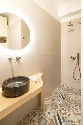 a bathroom with a sink and a mirror at Central Modern Studio with balcony,1 min to Metro,10 min to Acropolis in Athens
