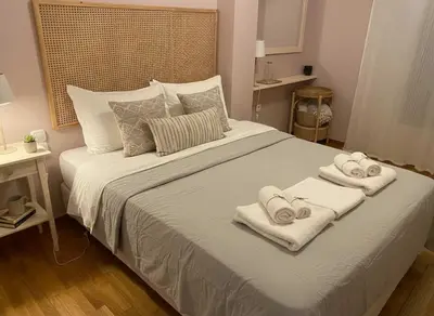 a bedroom with a bed with towels on it at Iris 2 Bedroom with Balcony in Pagkrati in Athens