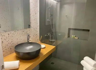 a bathroom with a black bowl sink and a shower at Iris 2 Bedroom with Balcony in Pagkrati in Athens
