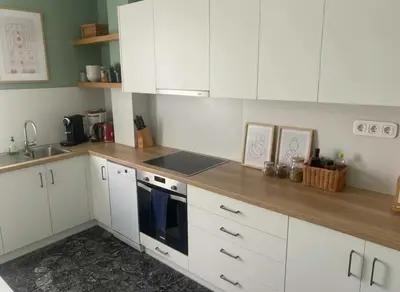 a kitchen with white cabinets and a sink at Iris 2 Bedroom with Balcony in Pagkrati in Athens