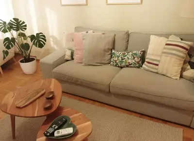 a living room with a couch and a table at Iris 2 Bedroom with Balcony in Pagkrati in Athens