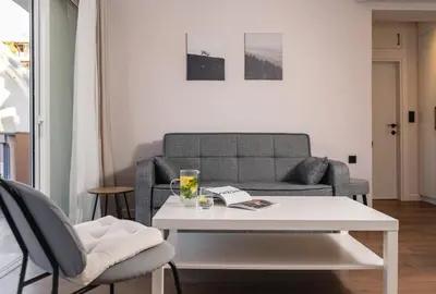 a living room with a couch and a table at Athens Neos Kosmos 1BDR apt near to metro station in Athens