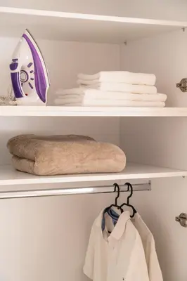 a closet with white towels and a towel rack at Athens Neos Kosmos 1BDR apt near to metro station in Athens