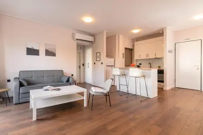 a living room with a couch and a table at Athens Neos Kosmos 1BDR apt near to metro station in Athens