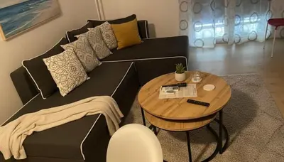 a black couch with a table in a living room at Urban Soul Modern 2BR Retreat in Exarcheia in Athens